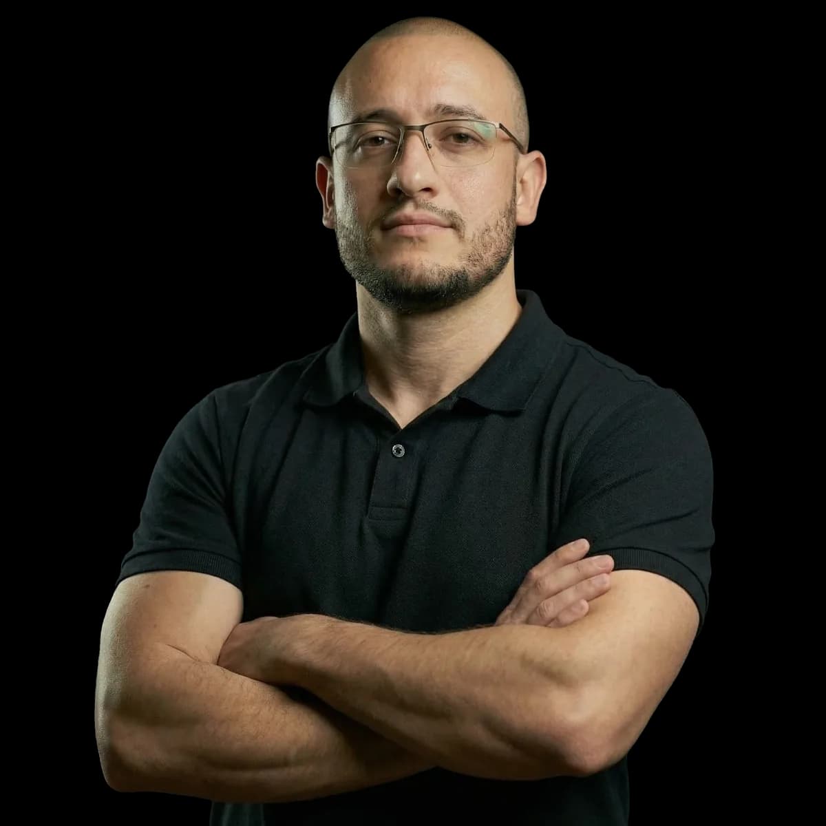 Cristiano Pereira, arms crossed, wearing a black polo shirt